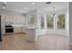 Open kitchen with modern appliances, light countertops, and adjacent breakfast nook at 12824 Cloverdale Ln, Clermont, FL 34711
