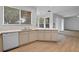 Open kitchen with modern appliances and spacious countertops overlooking carpeted living room at 12824 Cloverdale Ln, Clermont, FL 34711