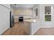 Bright kitchen with stainless steel appliances, a breakfast bar, and hardwood floors at 12824 Cloverdale Ln, Clermont, FL 34711