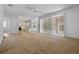 Open living space with sliding glass doors and view of the kitchen at 12824 Cloverdale Ln, Clermont, FL 34711