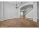 Spacious living room with neutral carpet, chandelier and staircase at 12824 Cloverdale Ln, Clermont, FL 34711