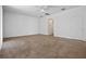 Open-concept living room with a ceiling fan and a doorway to another room at 12824 Cloverdale Ln, Clermont, FL 34711