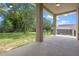 Covered patio with sturdy support columns and a beautiful backyard view at 12824 Cloverdale Ln, Clermont, FL 34711