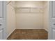 Walk-in closet featuring wire shelving, neutral walls, and carpet at 12824 Cloverdale Ln, Clermont, FL 34711