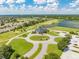Scenic aerial shot showcases the community clubhouse, golf course, and waterways with surrounding neighborhood at 130 Club Villas Ln, Kissimmee, FL 34744