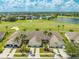 Aerial view features residences near a golf course, blending homes with recreational greenery at 130 Club Villas Ln, Kissimmee, FL 34744