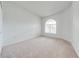 Bedroom with carpet and natural light from arched window, creating a comfortable and inviting space at 130 Club Villas Ln, Kissimmee, FL 34744