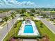 Inviting aerial view of the community pool area with comfortable seating and lush landscaping at 130 Club Villas Ln, Kissimmee, FL 34744