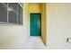 An exterior view of the home's green front door with a window and light fixture at 130 Club Villas Ln, Kissimmee, FL 34744