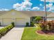 Charming single-story home with attached garages, manicured landscaping, and a well-maintained lawn at 130 Club Villas Ln, Kissimmee, FL 34744