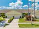 Inviting single-story home with attached garages, green landscaping, and a well-manicured front yard at 130 Club Villas Ln, Kissimmee, FL 34744