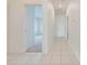 Hallway with ceramic tile flooring leading to living area and bedrooms at 130 Club Villas Ln, Kissimmee, FL 34744