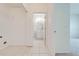 Hallway view showing the entrance to the laundry area and an adjacent bathroom with white fixtures at 130 Club Villas Ln, Kissimmee, FL 34744