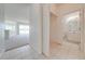 Hallway leading to the living room and bathroom, complete with tile flooring for easy maintenance at 130 Club Villas Ln, Kissimmee, FL 34744