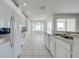 Kitchen with white appliances and tile flooring at 130 Club Villas Ln, Kissimmee, FL 34744