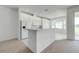 Kitchen featuring white cabinets, bar seating, and open layout at 130 Club Villas Ln, Kissimmee, FL 34744