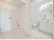 Bright laundry area with washer and dryer hookups next to a bathroom featuring white vanity and toilet at 130 Club Villas Ln, Kissimmee, FL 34744