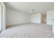 Spacious carpeted living room with ceiling fan and large sliding glass doors at 130 Club Villas Ln, Kissimmee, FL 34744