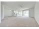 Bright living room with neutral carpet, white walls, and a ceiling fan at 130 Club Villas Ln, Kissimmee, FL 34744