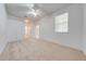 Main bedroom features a ceiling fan, neutral carpet, and an ensuite bathroom for added comfort and privacy at 130 Club Villas Ln, Kissimmee, FL 34744