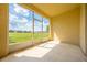 Enclosed patio with screen windows offering a view of the lawn and sky at 130 Club Villas Ln, Kissimmee, FL 34744