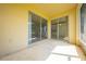 Enclosed patio showing sliding glass doors leading to the interior of the house at 130 Club Villas Ln, Kissimmee, FL 34744