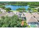 Aerial view showcasing the property, solar panels, neighborhood, and nearby lake at 13822 Darchance Rd, Windermere, FL 34786
