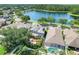 Beautiful home with solar panels is near a tranquil lake, surrounded by lush greenery and mature trees at 13822 Darchance Rd, Windermere, FL 34786