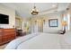 Spacious bedroom featuring wood floors, tray ceilings, and decorative furniture at 13822 Darchance Rd, Windermere, FL 34786
