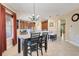 Dining area features modern chandelier and breakfast bar, adjacent to kitchen with tiled floors at 13822 Darchance Rd, Windermere, FL 34786