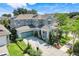 Beautiful two-story home featuring a teal garage door, and manicured landscaping at 13822 Darchance Rd, Windermere, FL 34786