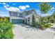 Charming two-story home with a well-manicured lawn, teal garage door, and welcoming front porch at 13822 Darchance Rd, Windermere, FL 34786