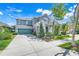Charming two-story home with a well-manicured lawn, teal garage door, and welcoming front porch at 13822 Darchance Rd, Windermere, FL 34786
