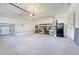 Spacious garage with ample storage space, utility shelves, and easy access to the home at 13822 Darchance Rd, Windermere, FL 34786