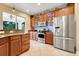 Kitchen boasts stainless steel appliances, granite countertops, and ample cherry wood cabinetry at 13822 Darchance Rd, Windermere, FL 34786