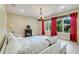 Comfortable living room with a cozy sofa, electric fireplace, and large windows with red drapes at 13822 Darchance Rd, Windermere, FL 34786
