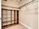 Walk-in closet featuring wooden shelves and hanging racks at 13822 Darchance Rd, Windermere, FL 34786