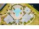 Aerial view of the community pool with chairs and tables plus a splash pad and two covered lounging areas at 14250 Sapelo Beach Dr, Orlando, FL 32827