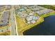 Aerial view of community tennis and basketball courts, playground, community pool with clubhouse, parking, and a lake at 14250 Sapelo Beach Dr, Orlando, FL 32827
