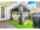 Backyard oasis with a stylish gazebo, outdoor seating, artificial turf, and a grill at 14250 Sapelo Beach Dr, Orlando, FL 32827
