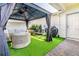 Beautiful backyard with a modern gazebo, outdoor seating, artificial turf, and barbecue grill at 14250 Sapelo Beach Dr, Orlando, FL 32827