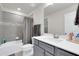 Well-lit bathroom featuring gray tile, a shower-tub combination, and a modern vanity at 14250 Sapelo Beach Dr, Orlando, FL 32827