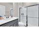 Bathroom with glass shower door and gray vanity at 14250 Sapelo Beach Dr, Orlando, FL 32827