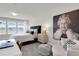 Bedroom with a large window with a plush upholstered headboard, neutral tones, and stylish decor at 14250 Sapelo Beach Dr, Orlando, FL 32827