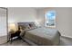 Cozy bedroom with a comfortable bed, side tables with lamps, and a window view at 14250 Sapelo Beach Dr, Orlando, FL 32827