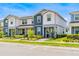 Townhouse exterior featuring a two-story design with manicured landscaping at 14250 Sapelo Beach Dr, Orlando, FL 32827