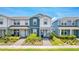 Charming townhouse with blue and white exterior and landscaped front yard on a sunny day at 14250 Sapelo Beach Dr, Orlando, FL 32827