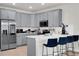 Beautiful gray kitchen featuring a breakfast bar with stylish seating at 14250 Sapelo Beach Dr, Orlando, FL 32827