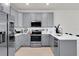 Modern kitchen with stainless steel appliances and gray cabinetry at 14250 Sapelo Beach Dr, Orlando, FL 32827