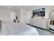 Bright bedroom with a sleek dresser, large screen TV, and comfortable, modern decor with natural light at 14250 Sapelo Beach Dr, Orlando, FL 32827
